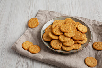Salty Round Crackers on a Plate, side view. Copy space.