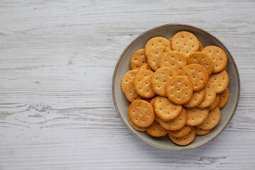 Salty Round Crackers on a Plate, top view. Flat lay, overhead, from above. Copy space.