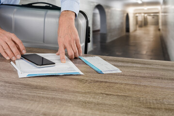Closeup of male businessman checking travel insurance contract before flight