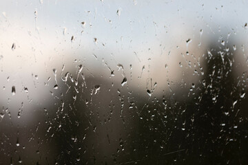 Large raindrops on the window glass, weather, rain, forecast, rainy window background