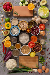 Assortment of healthy food in flat lay. Organic vegetables, fruits, greens, spices, meat, vegetable oil, cereals and nuts