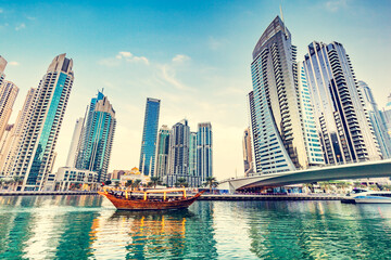 Fototapeta na wymiar Dubai marina and tourist boat at sunset.