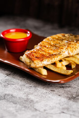 Chicken steak. Served with honey-mustard sauce.