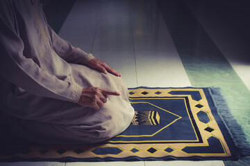 religious muslim man pray on prayer cloth in mosque,gester of prayer,concept for rite in...