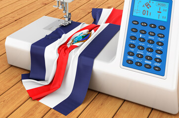 Sewing machine with Costa Rican flag on the wooden table. 3D rendering