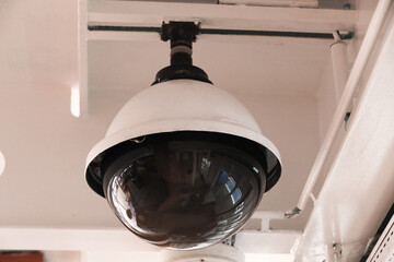 Surveillance cameras and a loudspeaker on the bulkhead of the ship's hull.