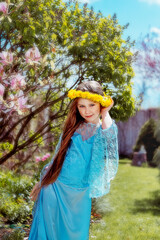 Ukrainian girl in a yellow wreath and blue dress