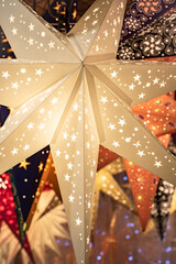 Colourful illuminated Christmas stars on sale at Bath Christmas market