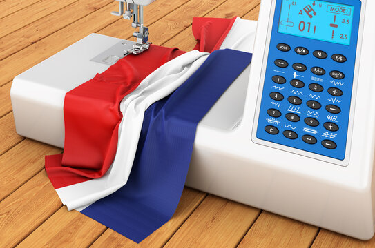 Sewing machine with the Netherlands flag on the wooden table. 3D rendering