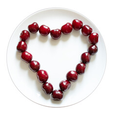 Ripe red cherries on a heart-shaped plate with an empty white plate in the center. Sweet red seasonal fruits. Flat lay. White background