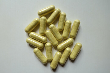 Group of yellowish green capsules of quercetin dietary supplement from above