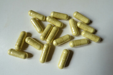 Many yellowish green capsules of quercetin dietary supplement from above