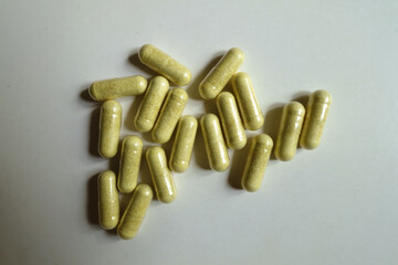 View of multiple yellowish green capsules of quercetin dietary supplement from above