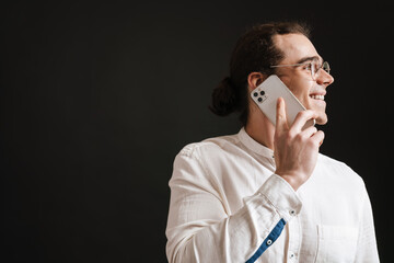 Young smiling man with long hair in shirt and glasses