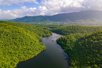 Aerial landscape with green hills, river and forest