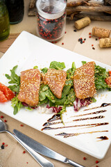 salad with spinach and salmon in teriyaki sauce with tomatoes
