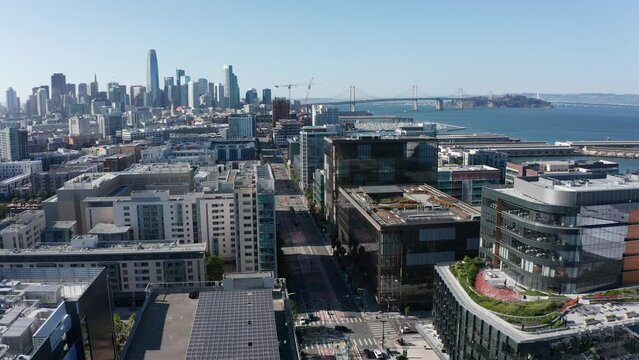 Aerial shot flying over Mission Bay and 3rd Street towards downtown San Francisco. 4K