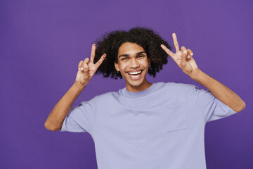 Young happy smiling handsome latin curly man with piercing