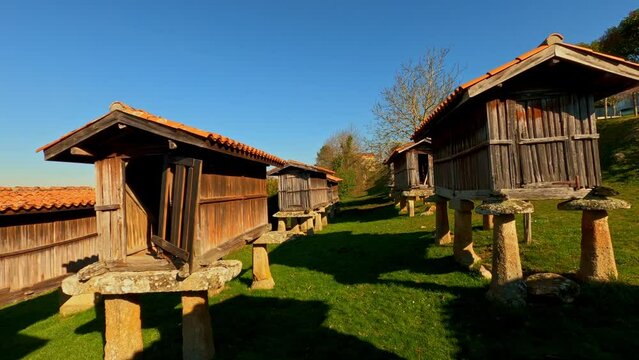 Establisher shot of many traditional wooden granaries in Ourense, Spain