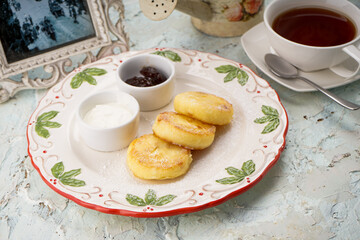 cheese cake dessert in a white plate on the table with tea
