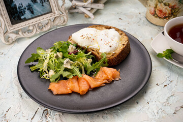 breakfast fresh salad with salmon and bruschetta with spread
