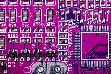 macro closeup shot of microchip on red printed circuit board, computer motherboard with components