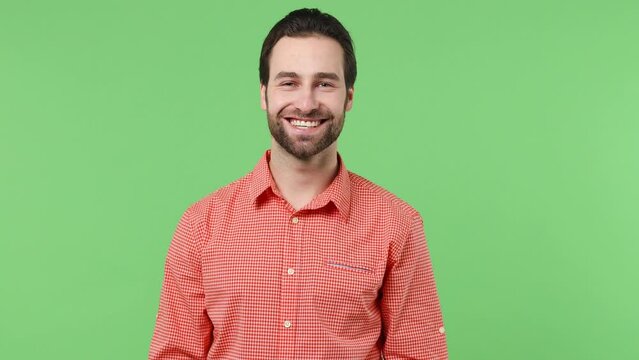 Blithesome charismatic cheerful happy young brunet bearded man 20s years old wears pink shirt looking camera smiling isolated plain green background studio portrait. People emotions lifestyle concept