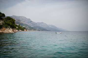 Landscape of town in the Adriatic sea coast under mountain in Croatia, during summer sunny day