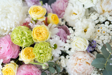 Delicate bouquet of pastel shades of peonies and chrysanthemums