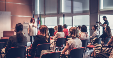 Woman giving presentation on business conference event.