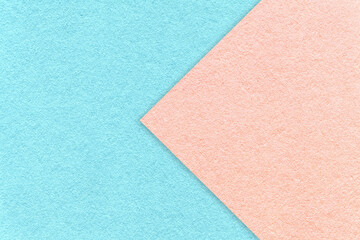 Fototapeta na wymiar Texture of light blue paper background, half two colors with pink arrow. Structure of dense craft rose cardboard