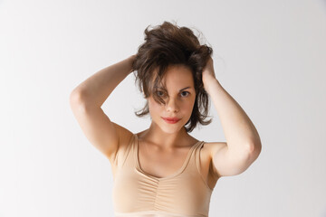 Fototapeta premium Young pretty woman with well-kept skin without makeup isolated on white studio background. Spa, cosmetics, face lifting and skin care concept