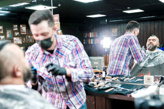 Beard dyeing in a barbershop. a young master applies paint