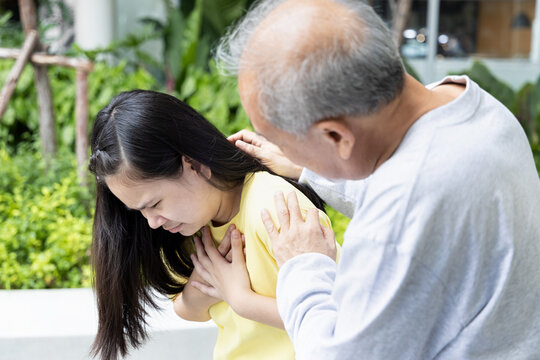 Sick daughter with nausea being cared by late married senior father or niece with old aging grandfather