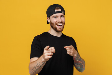 Young confident leader bearded tattooed man 20s he wears casual black t-shirt cap point index...