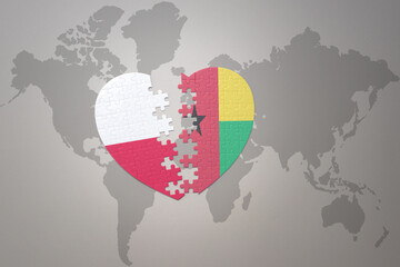 puzzle heart with the national flag of guinea bissau and poland on a world map background.Concept.