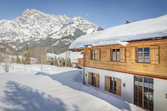 Wooden chalet in the alps on a sunny winter day