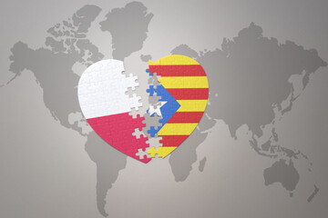 puzzle heart with the national flag of catalonia and poland on a world map background.Concept.