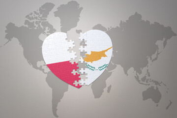 puzzle heart with the national flag of cyprus and poland on a world map background.Concept.