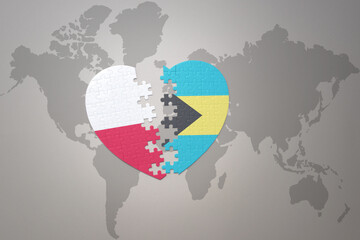 puzzle heart with the national flag of bahamas and poland on a world map background.Concept.