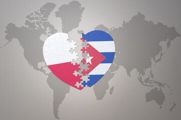 puzzle heart with the national flag of cuba and poland on a world map background.Concept.