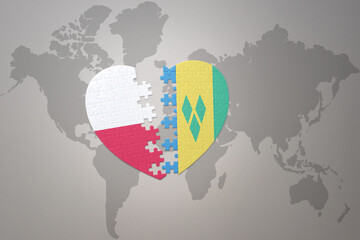 puzzle heart with the national flag of saint vincent and the grenadines and poland on a world map background.Concept. - obrazy, fototapety, plakaty