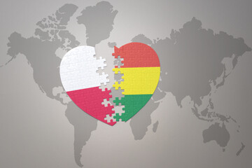 puzzle heart with the national flag of bolivia and poland on a world map background.Concept.