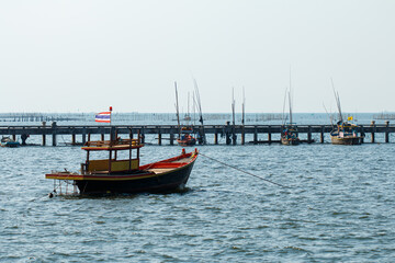Fototapeta premium A fishing boat moored in the sea near a jetty