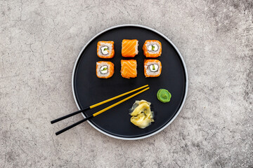 Sushi roll set with salmon and cream cheese on plate. Japanese food