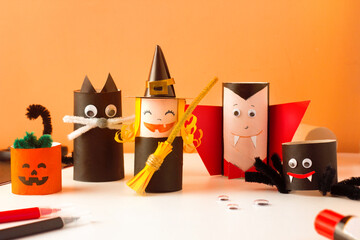 Handmade Halloween craft funny monsters. Cute cat, spooky vampire, scary witch. Reuse concept, decoration
