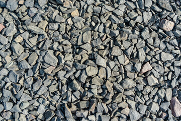Grey rubble texture. Gravel pebbles stone background. Gray small rocks ground.