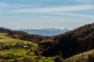 Fototapeta na wymiar Wonderful view on green hills and mountains. Rural scenery on rolling hills