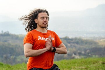 Fototapeta premium Young man meditating yoga on the mountain. Relax and calm