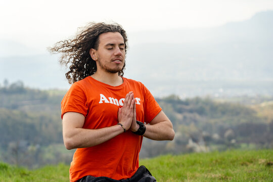Young man meditating yoga on the mountain. Relax and calm